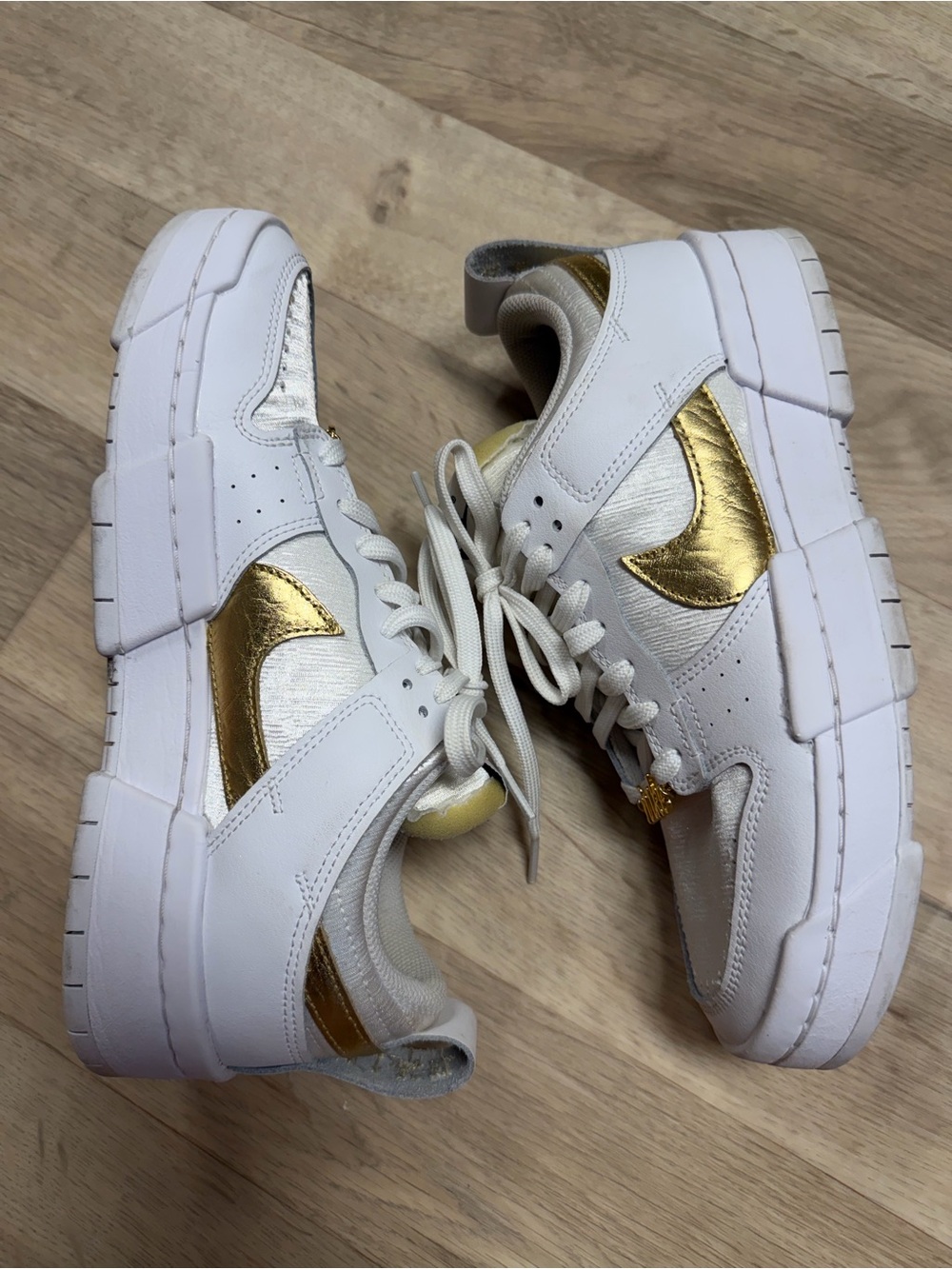 Nike Women's White Sneakers with Gold Swoosh